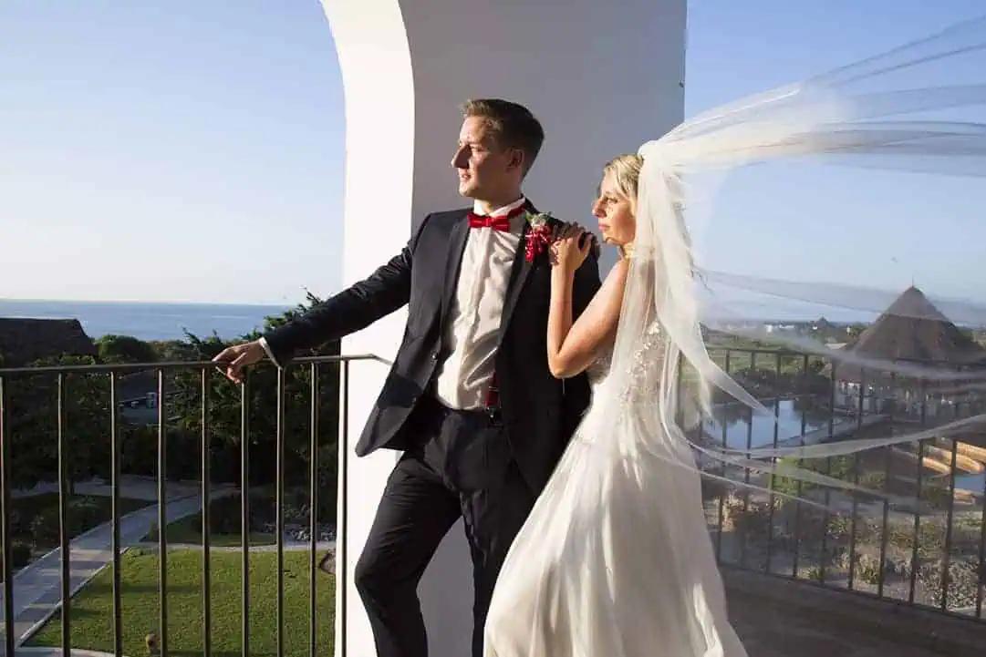 A bride's veil catching the ocean light