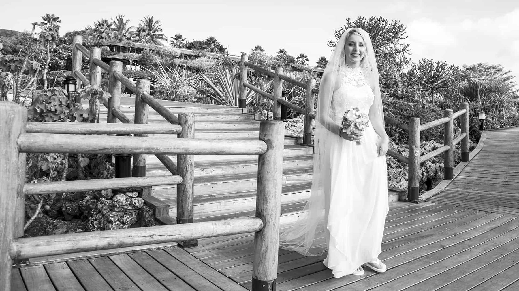 A black and white portrait of a couple on a jetty