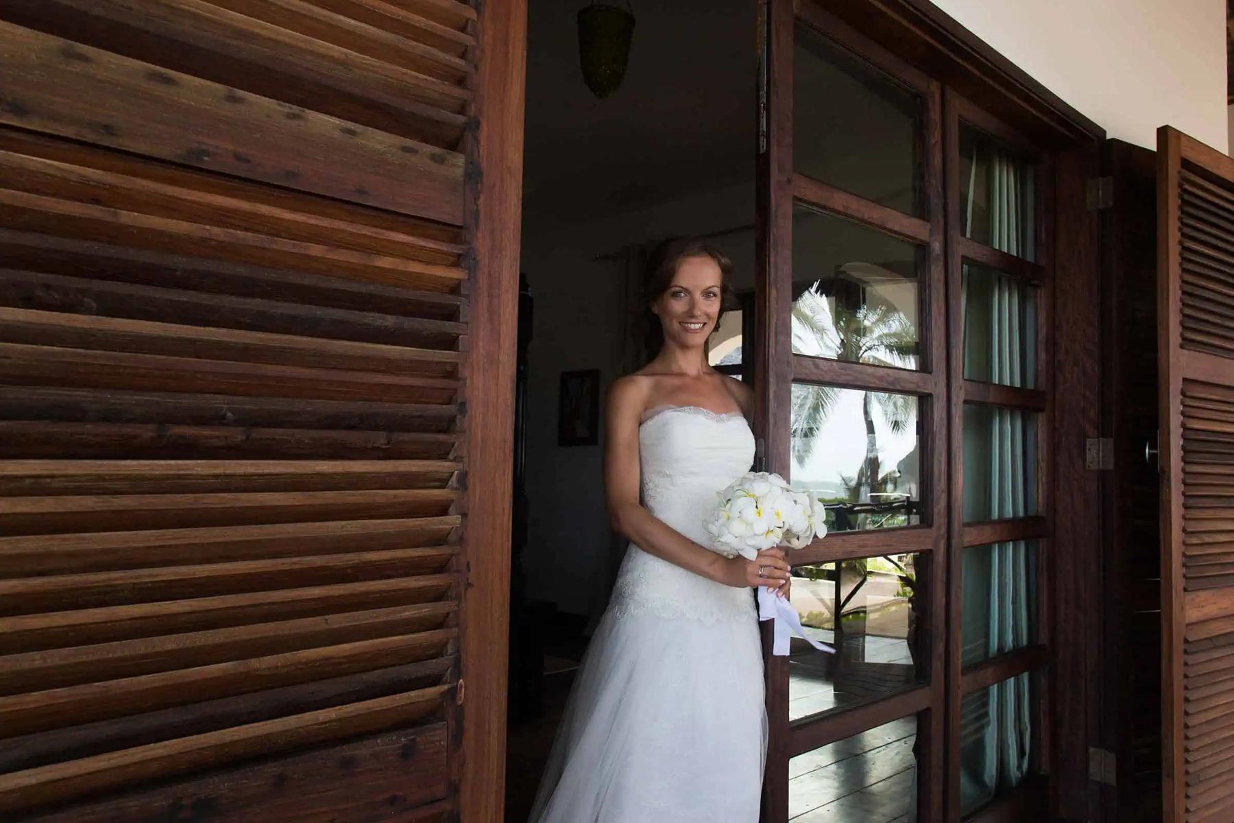 A bride framed in a bougainvillea doorway